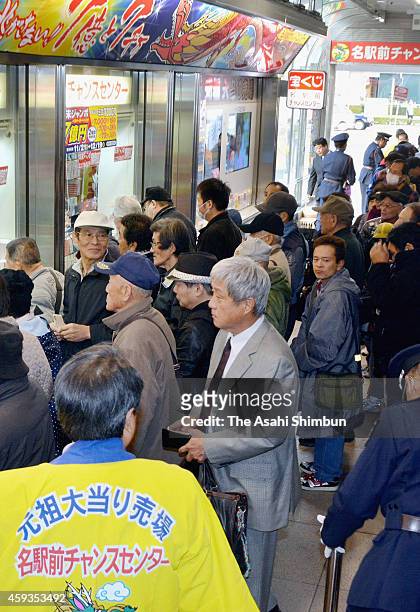 People queue for purchasing the Year End Jumbo Lottery, whose first prize will be 700 million Japanese yen including the prizes for adjacent numbers,...