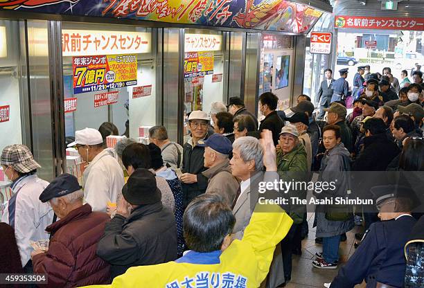 People queue for purchasing the Year End Jumbo Lottery, whose first prize will be 700 million Japanese yen including the prizes for adjacent numbers,...
