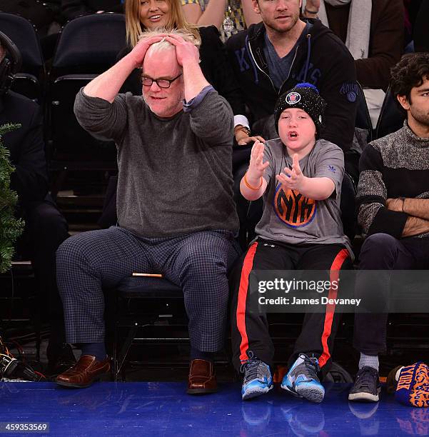 Phillip Seymour Hoffman and Cooper Alexander Hoffman attend the Oklahoma City Thunder vs New York Knicks game at Madison Square Garden on December...