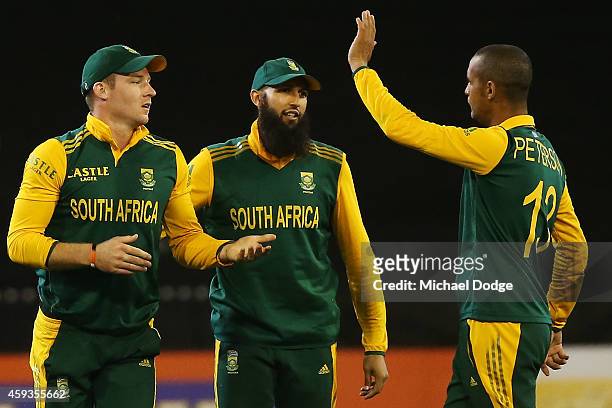 David Miller of South Africa gestures to Robin Petersen next to Hashim Amla after he was not sure if he caught out Pat Cummins of Australia during...