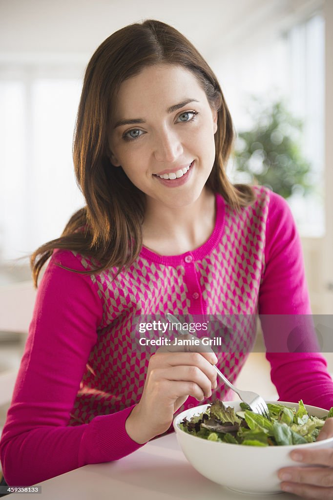 Woman eating salad