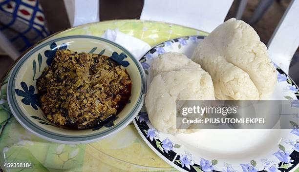 The most populal Nigerian cuisine, pounded yam is served with egusi soup, at a Lagos house party on November 2, 2014. Pounded yam, simply is a boiled...