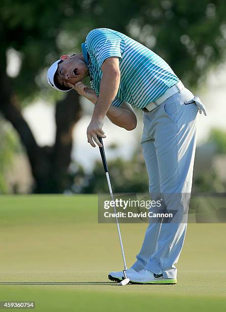 Rory McIlroy of Northern Ireland reacts as he just misses an eagle putt on the par 5, 14th hole during the second round of the 2014 DP World Tour...