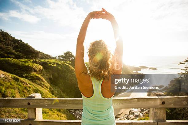 woman running for exercise. - back stretch stock pictures, royalty-free photos & images