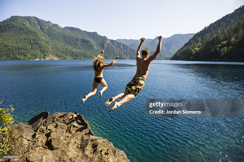 Man and woman cliff jumping