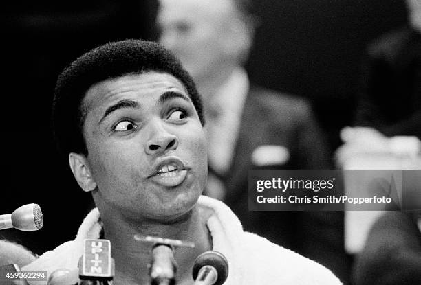 Muhammad Ali reacts during a press conference following the weigh-in for his first world heavyweight boxing championship fight against Joe Frazier at...