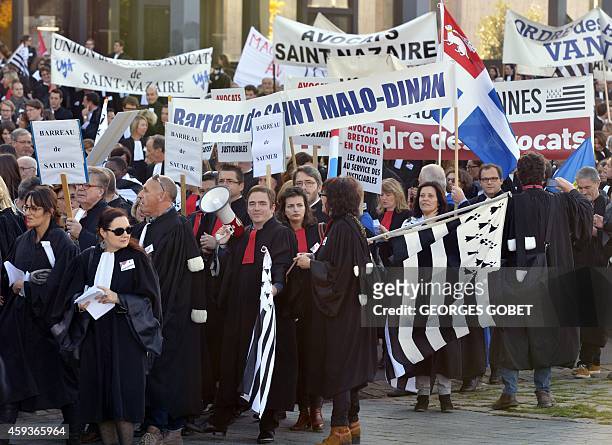 French lawyers dressed in their robes hold signs and flags of Brittany during a demonstration against a reform of their professional status in...