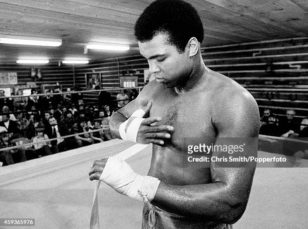 Muhammad Ali bandaging his hands during a training session for his second fight against Joe Frazier at Deer Lake, Pennsylvania on 24th January 1974....