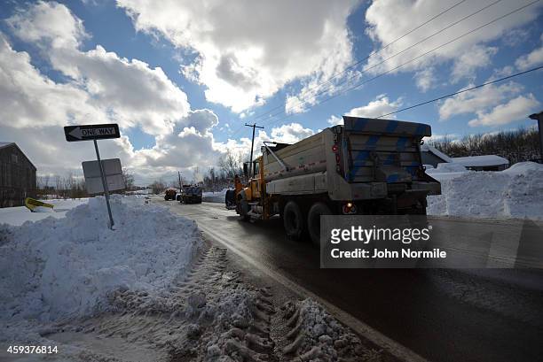 Lake effect snow clouds break apart as DOT trucks leave a staging area on November 20, 2014 in the suburb of Hamburg, Buffalo, New York. The record...