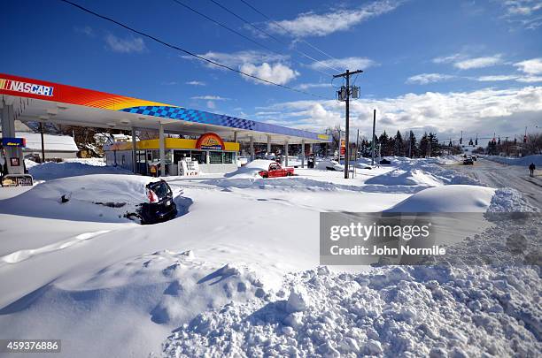 Abandoned cars wait to recovered at gas station on November 20, 2014 in the suburb of Blasdell, Buffalo, New York. The record setting Lake effect...