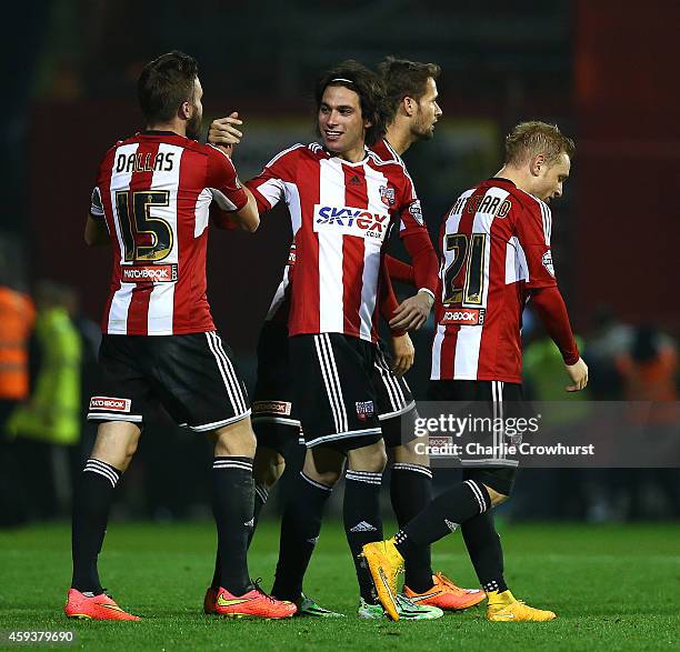 Jota of Brentford celebrates with team mates after scoring winning goal late on during the Sky Bet Championship match between Brentford and Fulham at...