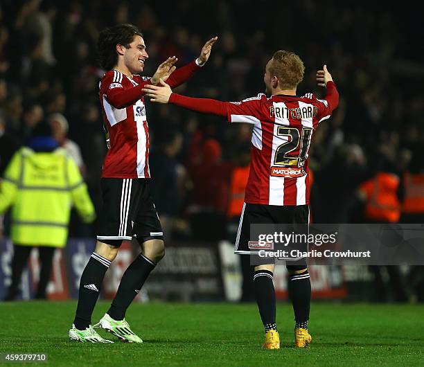 Jota of Brentford celebrates with team mate Alex Pritchard after scoring winning goal late on during the Sky Bet Championship match between Brentford...