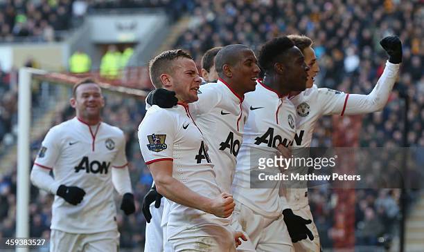 Tom Cleverley; Ashley Young and Danny Welbeckj of Manchester United celebrate James Chester of Hull City scoring an own goal during the Barclays...
