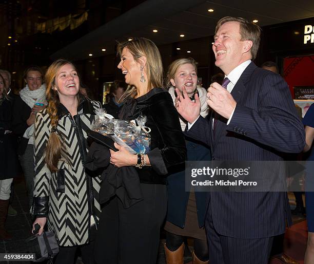 King Willem-Alexander of The Netherlands and Queen Maxima of The Netherlands pose with royalty fans who gave them chocolate while leaving the...