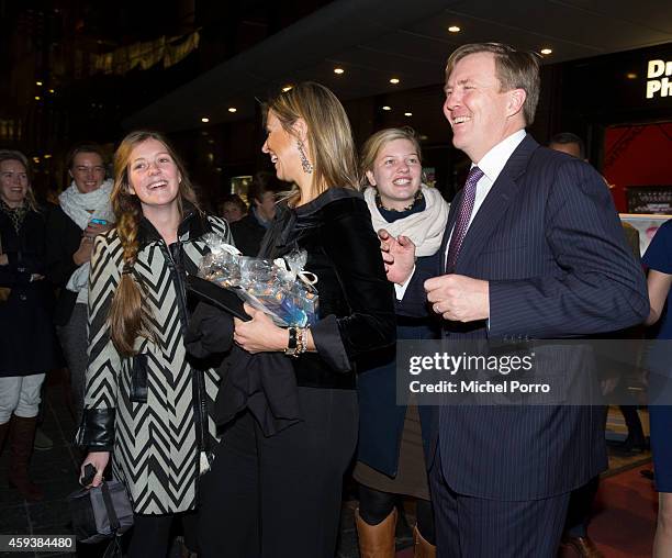 Queen Maxima of The Netherlands and King Willem-Alexander of The Netherlands pose with royalty fans who gave them chololate while leaving the...