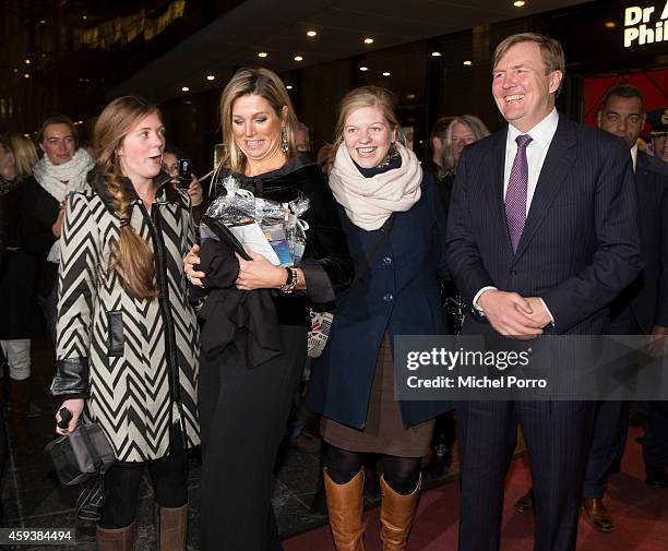 Queen Maxima of The Netherlands and King Willem-Alexander of The Netherlands pose with royalty fans who gave them chololate while leaving the...