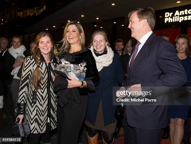 Queen Maxima of The Netherlands and King Willem-Alexander of The Netherlands pose with royalty fans who gave them chololate while leaving the...