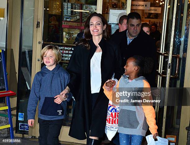 Shiloh Jolie-Pitt, Angelina Jolie and Zahara Jolie-Pitt leave Lee's Art Shop on November 21, 2014 in New York City.