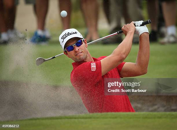 Adam Scott of Australia plays a shot out of a bunker on the third hole during day three of the Australian Masters at The Metropolitan Golf Course on...