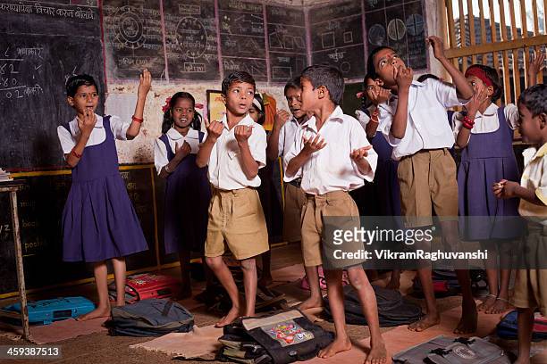 group of small indian children performing in a rural school - rural scene stock pictures, royalty-free photos & images