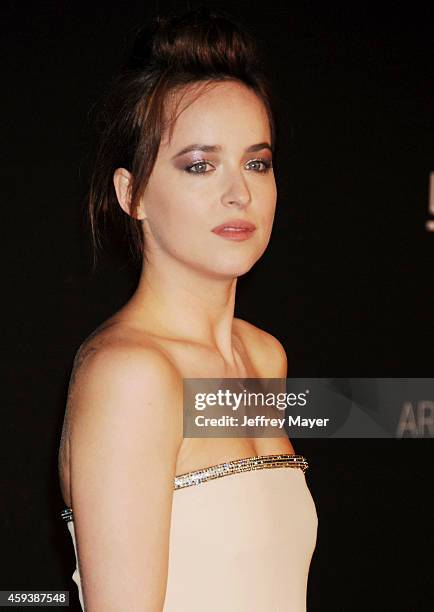 Actress Dakota Johnson attends the 2014 LACMA Art + Film Gala honoring Barbara Kruger and Quentin Tarantino presented by Gucci at LACMA on November...