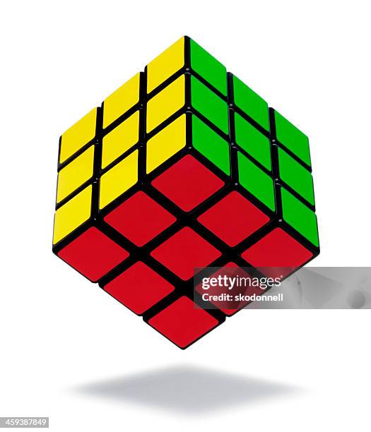 rubiks cube on white - puzzle cube stock pictures, royalty-free photos & images