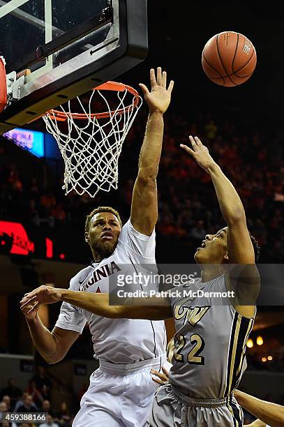 Joe McDonald of the George Washington Colonials drives to the basket against Justin Anderson of the Virginia Cavaliers in the first half during a...