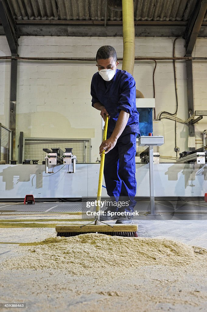 Factory worker sweeping portrait