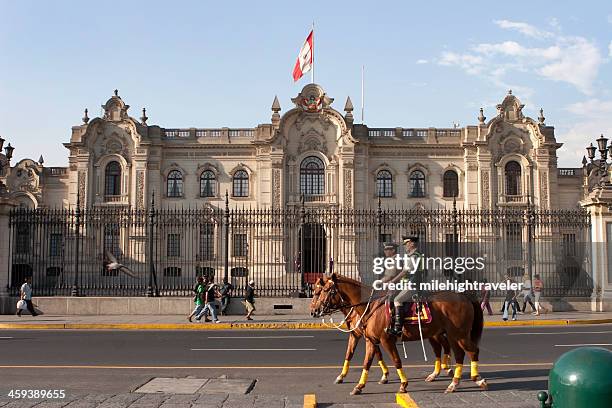 government palace pedestrians and mounted police in lima peru - plaza de armas stock pictures, royalty-free photos & images