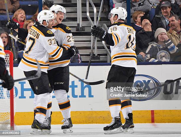 Matt Fraser of the Boston Bruins celebrates his third period goal with teammates Patrice Bergeron and Reilly Smith of the Boston Bruins during a game...