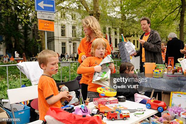children selling toys on queen's day in utrecht - koninginnedag stock pictures, royalty-free photos & images