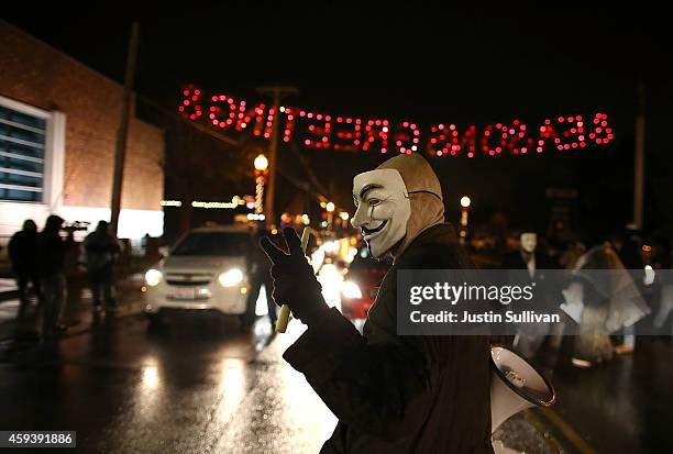 Demonstrator wears a Guy Fawkes mask as he protests the shooting death of 18-year-old Michael Brown on November 21, 2014 in Ferguson, Missouri....