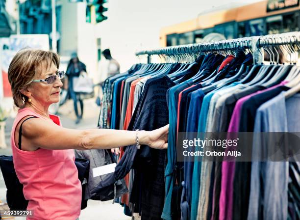 woman in the market - blue dress hanger stock pictures, royalty-free photos & images
