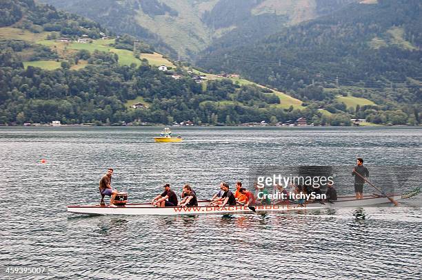 people rowing a dragon boat - zell am see stock pictures, royalty-free photos & images