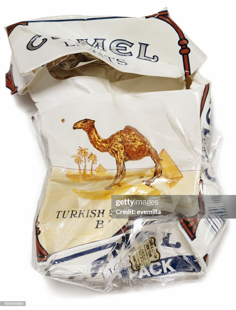 Crumpled packet of Camel Cigarettes on white