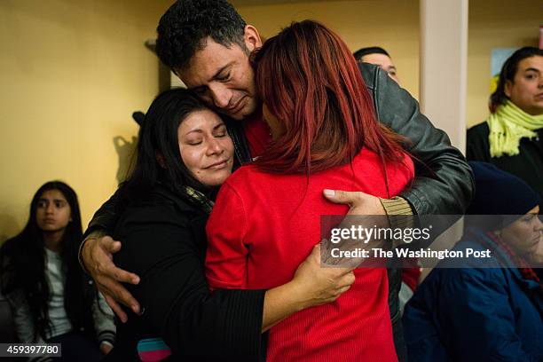 Family from DC helped by the announcement cries and hugs after hearing that they are now safe. From left to right is Enriqueta Juarez of Mexico, her...