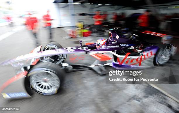 Jaime Alguersuari of Spain and Virgin Racing Formula E Team leaves the garage after making a pit stop during the FIA Formula E Putrajaya ePrix...