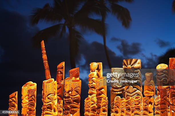 hawaiian tiki mask art and blue palm tree sky. - tiki stock pictures, royalty-free photos & images