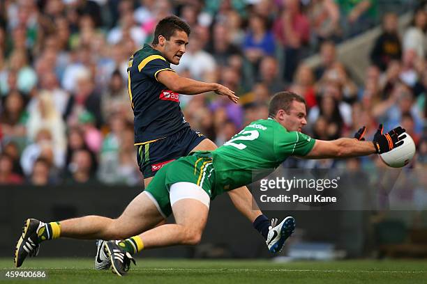 Neil McGee of Ireland attempts to smother a kick on goal by Chad Wingard of Australia during the International Rules Test Match between Australia and...