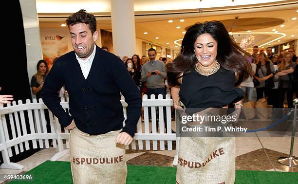 James Argent from 'The Only Way Is Essex' and Casey Batchelor celebrate a new Spudulike opening by taking part in a tradional potato sack race at...