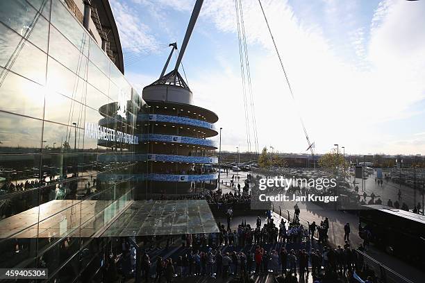 Fans wait the arrival of the team bus ahead of the Barclays Premier League match between Manchester City and Swansea City at Etihad Stadium on...