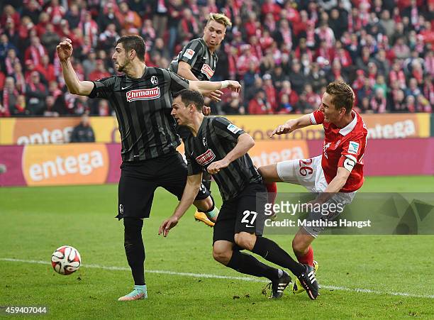 Niko Bungert of Mainz and Nicolas Hoefler of Freiburg compete for the ball during the Bundesliga match between FSV Mainz 05 and SC Freiburg at Coface...