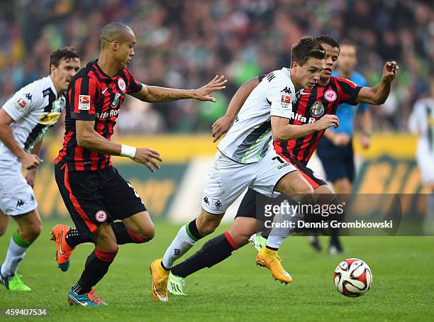 Patrick Herrmann of Borussia Moenchengladbach is chased by Timothy Chandler and Bamba Anderson of Eintracht Frankfurt during the Bundesliga match...
