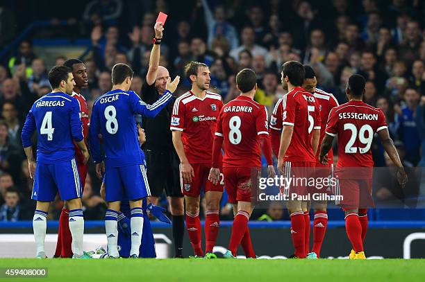 Referee Lee Mason shows Claudio Yacob of West Brom a red card during the Barclays Premier League match between Chelsea and West Bromwich Albion at...