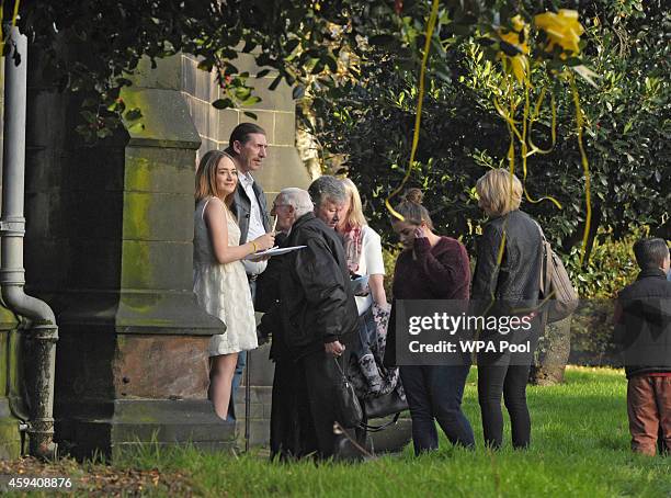 Lucy Henning welcomes family and friends as they arrive for a memorial service for murdered British aid worker Alan Henning at Eccles Parish Church...