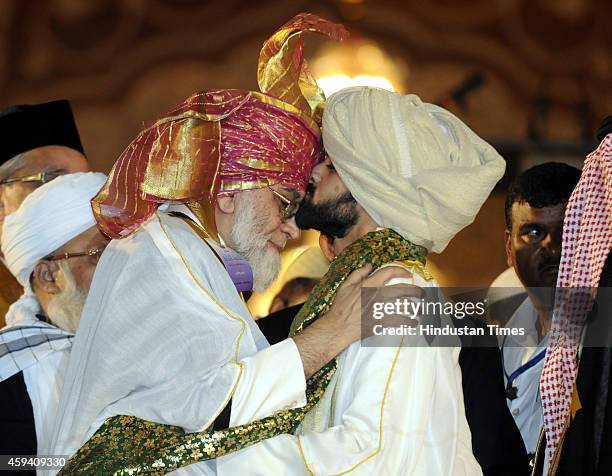 Shaban Ahmed Bukhari kisses the forehead of his father Syed Ahmed Bukhari, Shahi Imam of Delhis Jama Masjid, after his father anointed him as his...