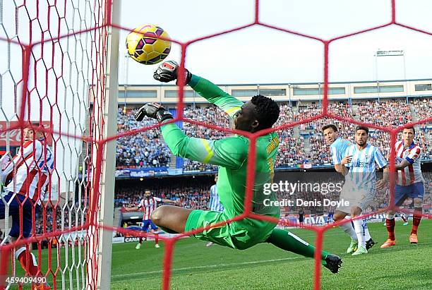 Idriss Kameni of Malaga CF fails to stop Tiago Mendes of Club Atletico de Madrid scoring his team's opening goal during the La Liga match between...