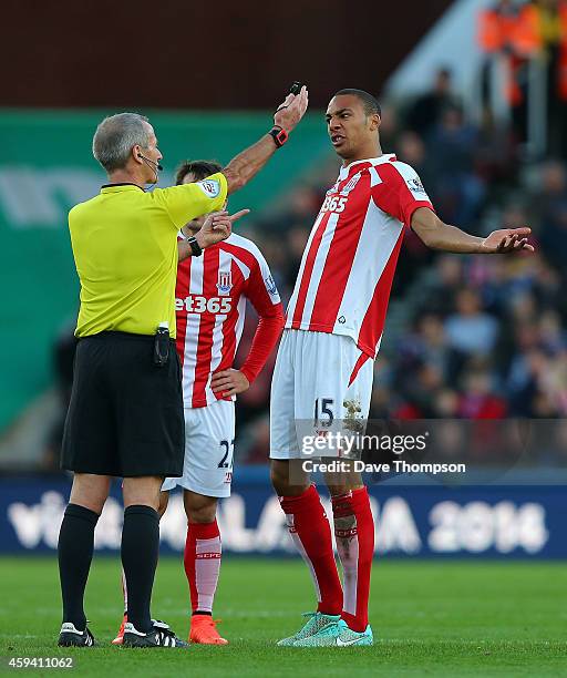 Steven Nzonzi of Stoke City and Referee Martin Atkinson exchange views during the Barclays Premier League match between Stoke City and Burnley at the...