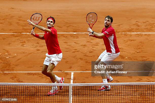 Roger Federer of Switzerland and Stanislas Wawrinka of Switzerland in action against Richard Gasquet of France and Julien Benneteau of France in the...