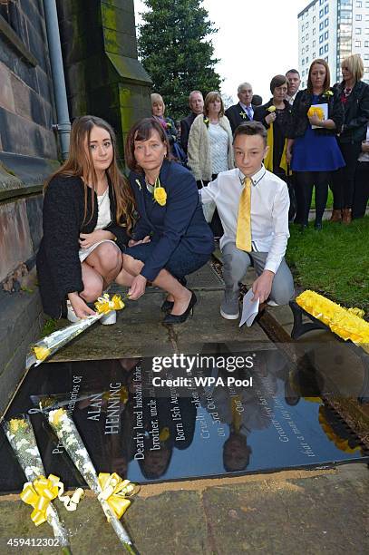 Barbara Henning and her children Lucy Henning and Adam Henning unveil a memorial stone at a memorial service for murdered British aid worker Alan...